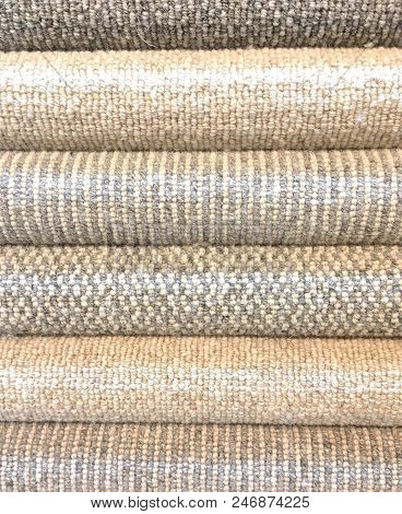 Rolled Carpet Samples On Display In A Carpet Shop With A Variety Of Brown To Beige Colour Options An