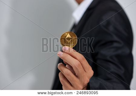 Golden Etherium In A Man Hand, Digitall Symbol Of A New Virtual Currency