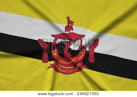 Brunei Darussalam Flag  Is Depicted On A Sports Cloth Fabric With Many Folds. Sport Team Waving Bann