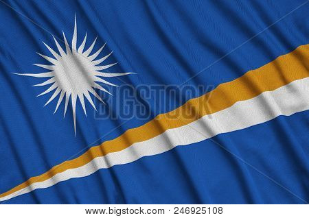 Marshall Islands Flag  Is Depicted On A Sports Cloth Fabric With Many Folds. Sport Team Waving Banne