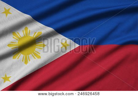 Philippines Flag  Is Depicted On A Sports Cloth Fabric With Many Folds. Sport Team Waving Banner