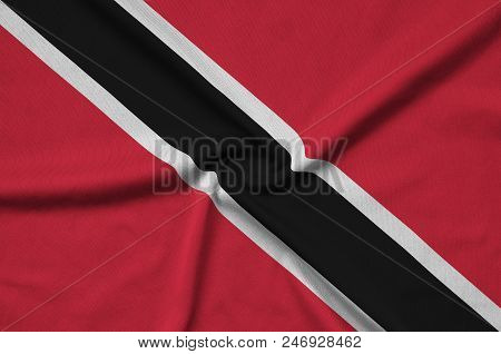 Trinidad And Tobago Flag  Is Depicted On A Sports Cloth Fabric With Many Folds. Sport Team Waving Ba