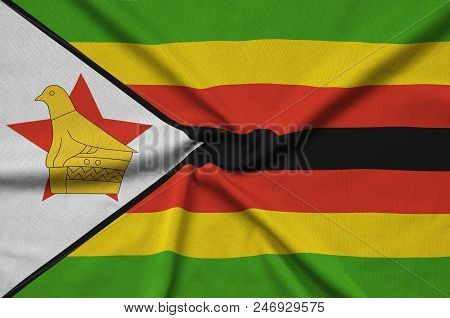 Zimbabwe Flag  Is Depicted On A Sports Cloth Fabric With Many Folds. Sport Team Waving Banner