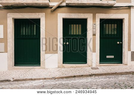 Simple Wooden Entrance Doors Are Arranged In A Row.