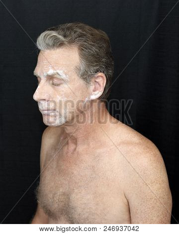 Male Wearing A Light Bentonite Clay Treatment Mask Thin Bentonite Clay Face Treatment Worn By A Guy.