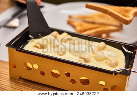 Swiss Food. Cheese Raclette With Mushrooms On Coupelles - Special Small Skillet For A Raclette