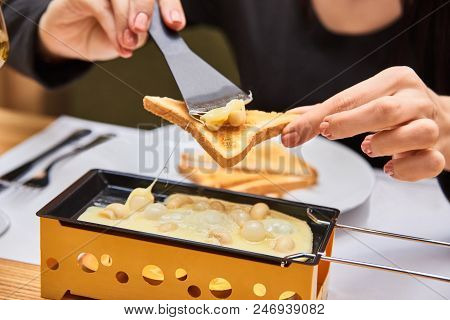 Swiss Food. Cheese Raclette With Mushrooms On Coupelles - Special Small Skillet For A Raclette