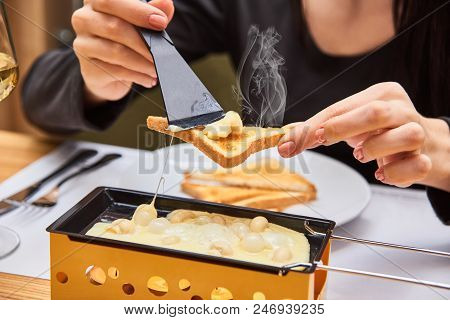 Swiss Food. Cheese Raclette With Mushrooms On Coupelles - Special Small Skillet For A Raclette