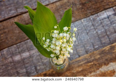 Bouquet Of Flowers Beautiful Smell Lily Of The Valley Or May-lily In Glass Vase On Rustic Old Vintag