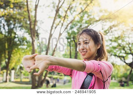 Close Up Of A Young Woman Warm Up Her Body By Stretching Her Arms To Be Ready For Exercising And Do 