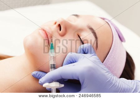 Woman Gets Beauty Facial Injections, Closeup. Anti-aging, Nourishing, Vitamins Treatment At Spa Salo