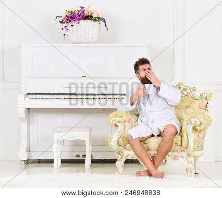 Man Sleepy In Bathrobe, Yawning, Drinks Coffee In Luxury Hotel In Morning, White Background. Man Wit