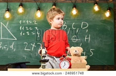 Child, Pupil On Calm Face Near Microscope. First Former Interested In Studying, Learning, Education.