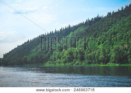 Shallow Mountain River Near Green Mountains, Blue Sky
