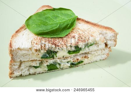 Hot Breakfast Sandwich With Cheese And Fresh Spinach