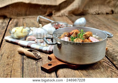 Old Saucepan With Garlic Soup, Fresh Garlic Bulbs, Cloves, Colored Pepper, Wooden Spoon, Croutons, L