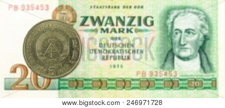 5 Mark Coin Against Historic 20 East German Mark Bank Note