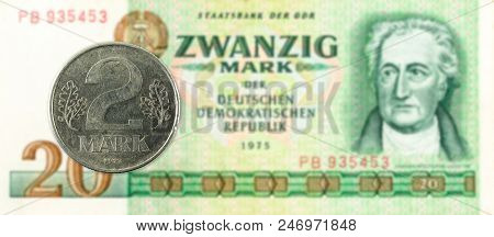2 Mark Coin Against Historic 20 East German Mark Bank Note