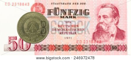 5 Mark Coin Against Historic 50 East German Mark Bank Note