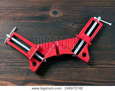 Angular Clamp On Work With Wood Lying On A Wooden Board