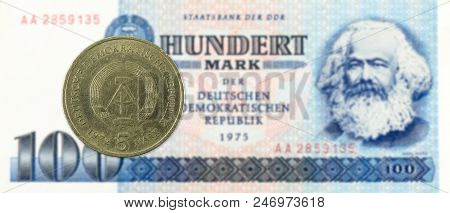 5 Mark Coin Against Historic 100 East German Mark Bank Note