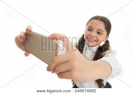 Let Me Take Selfie. Girl Cute Long Curly Hair Holds Smartphone Taking Selfie White Background. Child