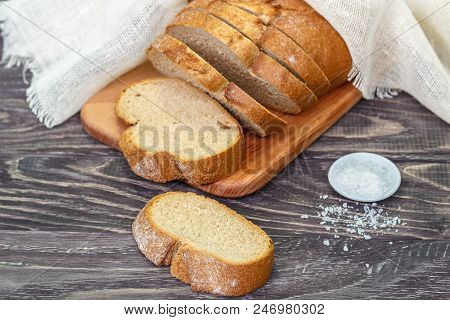 Still Life With Slices Of Bread On A Wooden Background