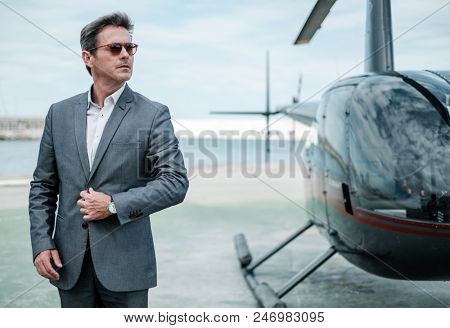 Businessman near private helicopter