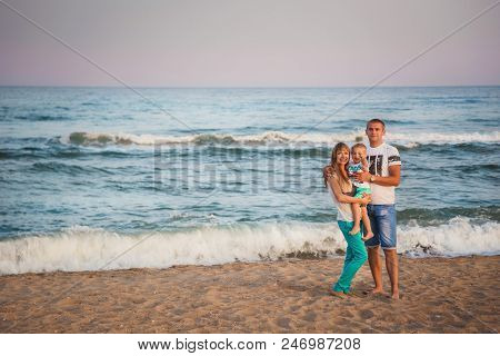 Odessa, Ukraine - September 02, 2014: Young Happy Loving Family Hugging At Beach Together Near The O