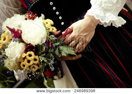 bride wearing a traditional hungarian wedding dress and groom in a traditional romanian costume - intereethnic marriage