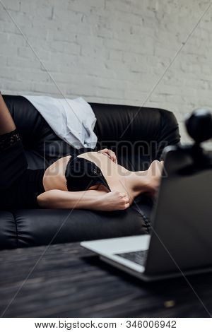 Cropped View Of Sexy Girl In Bra Posing At Laptop With Web Camera On Couch