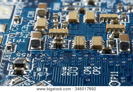 Computer Blue Motherboard With Brown Microcircuits And Different Electronic Components, Side View, M