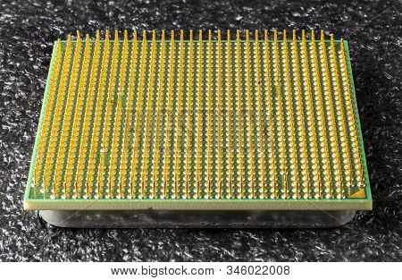 Old Computer Processor With Gold-plated Legs, On A Black Soft Backing, Close-up