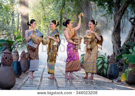 Beautiful Asian Woman Splashing Water During Tradition Festival Thai,songkran Festival.