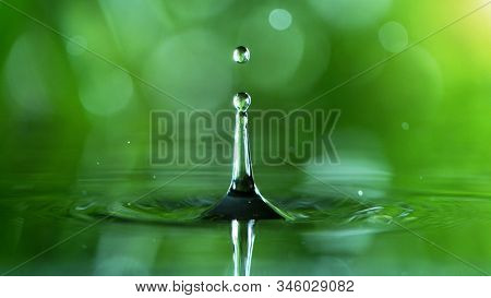 Dropping water in detail, spa and wellness concept. Shot on super macro lens, low depth of focus. Free space for text.