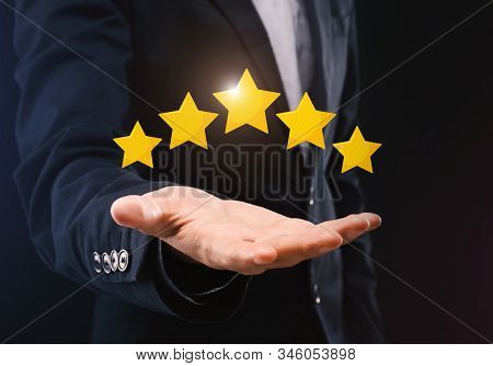 Best Business Services. Unrecognizable Businessman Holding Five Stars Icons On Open Hand, Demonstrat