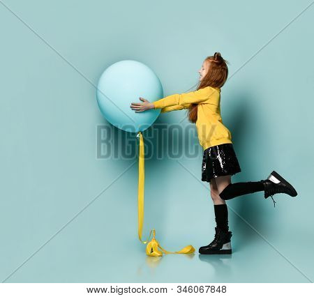 Ginger Teenage Kid With Fancy Hairstyle In Yellow Sweatshirt, Black Skirt, Knee-highs, Boots. Smilin