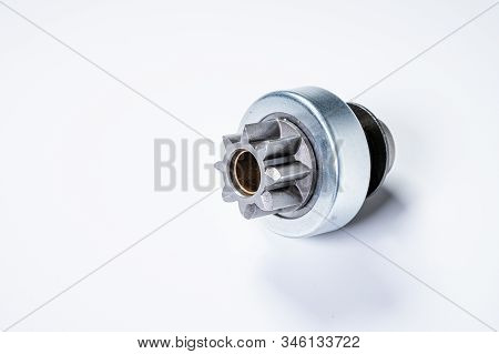 New Spare Parts - Starter Gear Drive For Motor Starter On A Gray Background. Classic Gear Transmissi