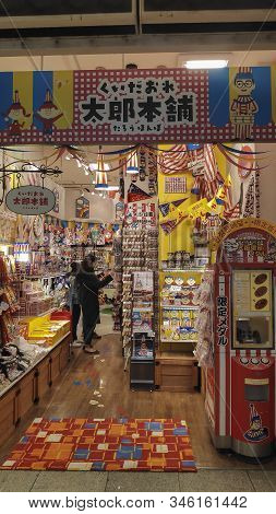 Osaka, Japan- 27 Nov, 2019: Souvenirs Shops With Kuidaore Taro Clown Decorated Goods In Dotombori Os