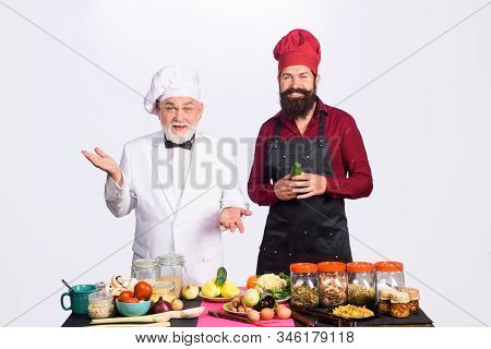 Two Chefs Cooking. Professional Culinary. Bearded Man In Kitchen Apron. Bearded Man Chef In Uniform.