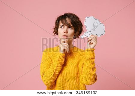 Pensive Young Brunette Woman Girl In Yellow Sweater Posing Isolated On Pastel Pink Background. Peopl