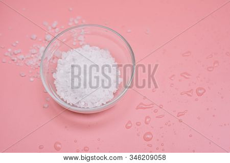 Glass Bowl With Sea Coarse White Salt On A Pink Background. Flat Lay, Copy Space. Spa Concept Or Tem