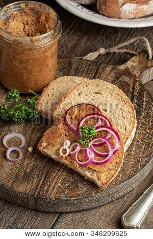 Slices Of Bread Slathered With Pork Lard Mixed With Ground Cracklings On A Rustic Background