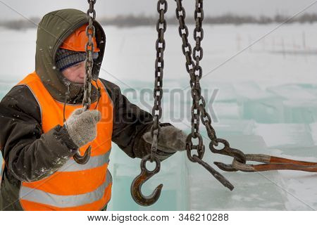 Slinger In Orange Helmet On Shipment Of Ice Blocks