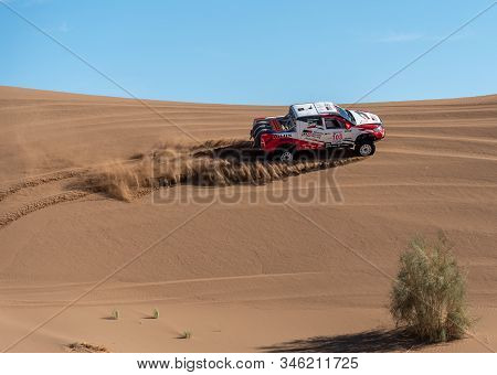 Zahedan, Baluchestan/iran-11/23/2018climbing Sand Dunes In Lut Desert With A Dakar Edition Race Car