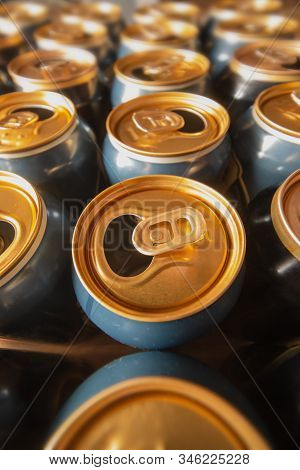 Open Cans Of Beer Standing On Wooden Floor. Wide Angle