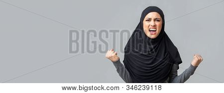 Screaming, Hate And Rage Concept. Angry Emotional Muslim Woman In Hijab Shouting In Fury Over Grey S