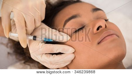 Aesthetic Cosmetology. Black Woman Getting Beauty Facial Injections In Cheekbones