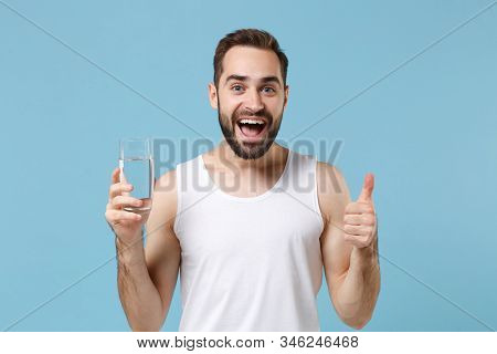 Bearded Young Man 20s Years Old Perfect Skin In White Shirt Hold Water Isolated On Blue Pastel Wall 