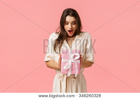 Amazement, Celebration And Holidays Concept. Surprised Girlfriend Holding Box Of Present, Didnt Expa